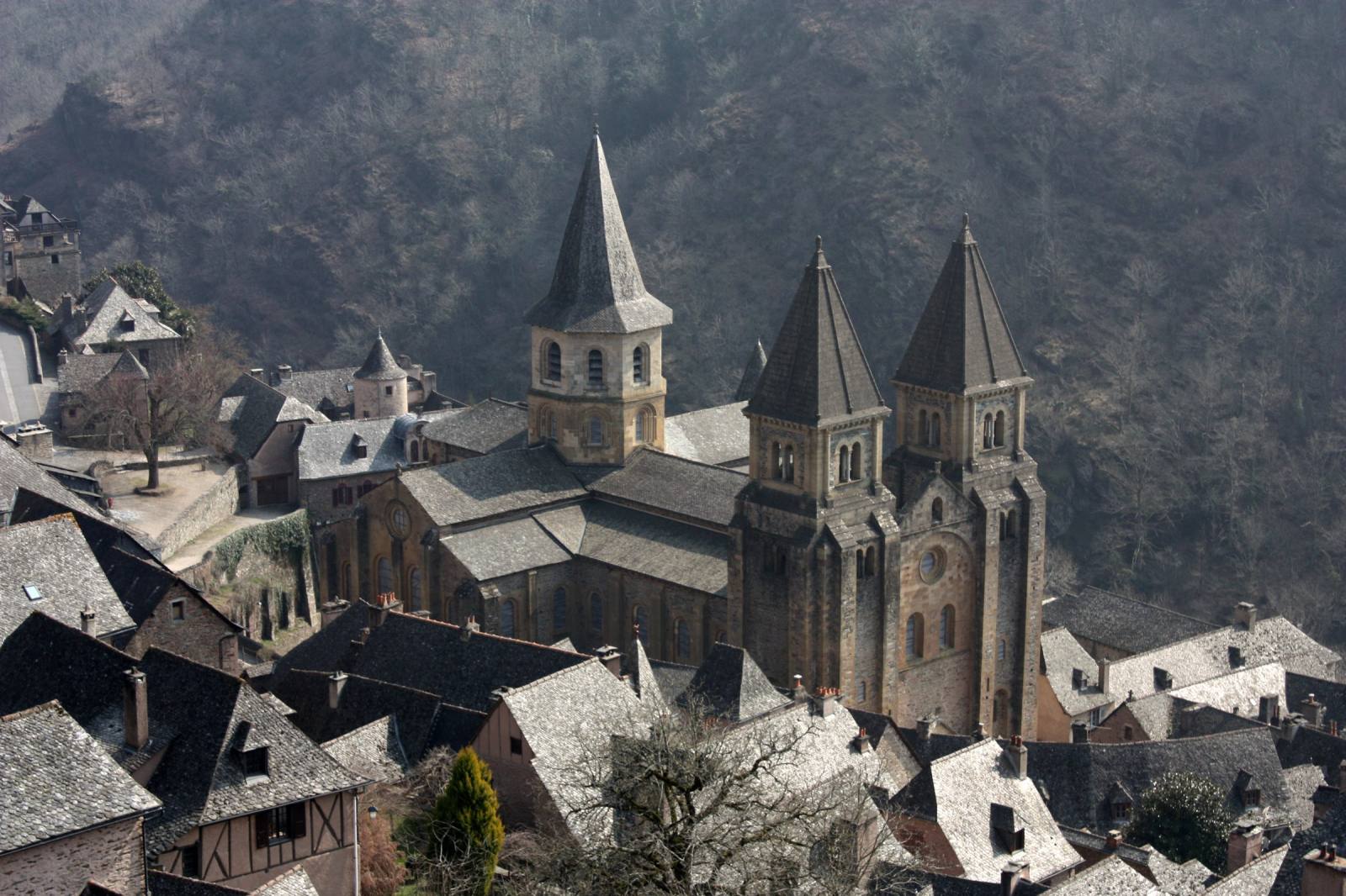 Façade of the Sainte-Foy abbey church in Conques, Aveyron, with its Romanesque bell tower