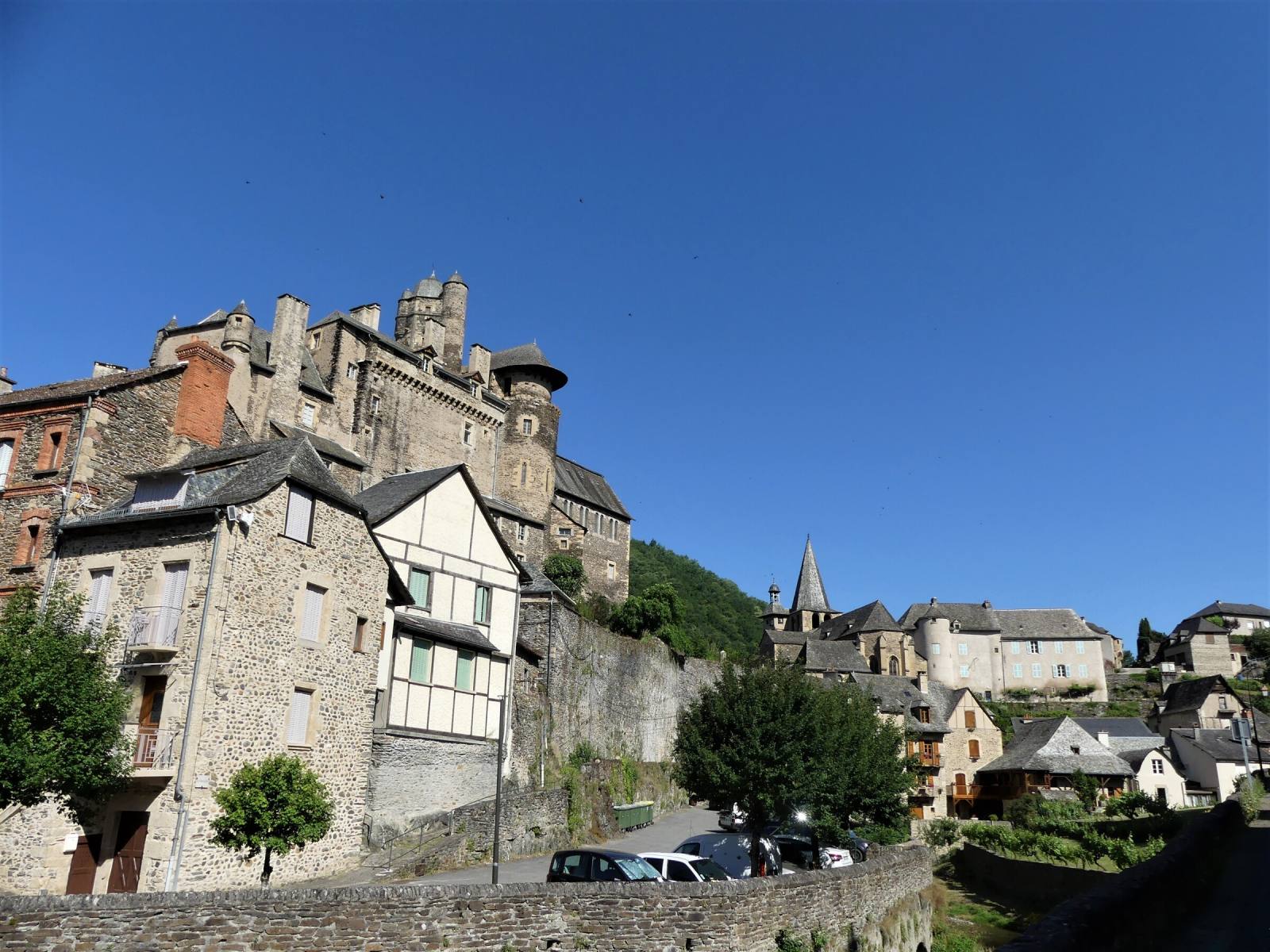 Estaing castle overlooking the village under a big blue sky, Aveyron