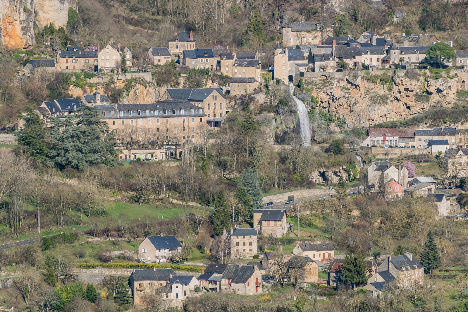 The Salles-la-Source waterfall gushing out in the heart of the village, Aveyron