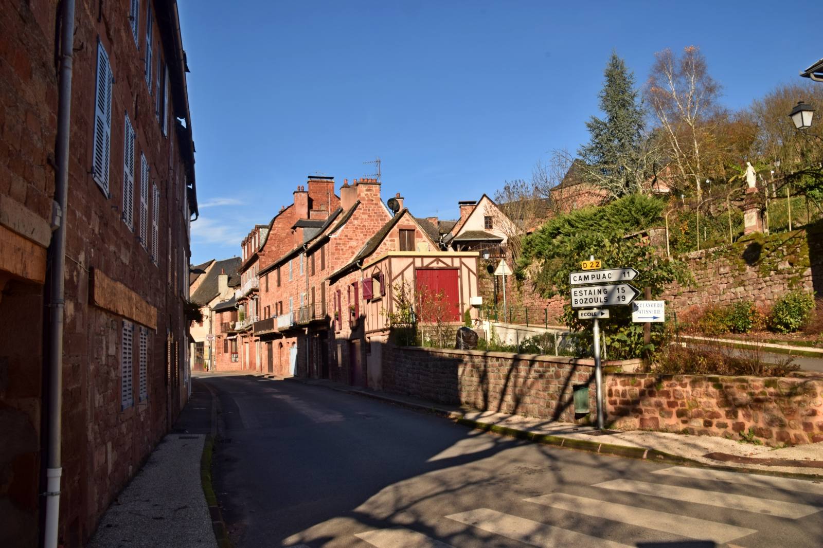 A street in the village of Villecomtal, Aveyron, with red sandstone and half-timbered houses